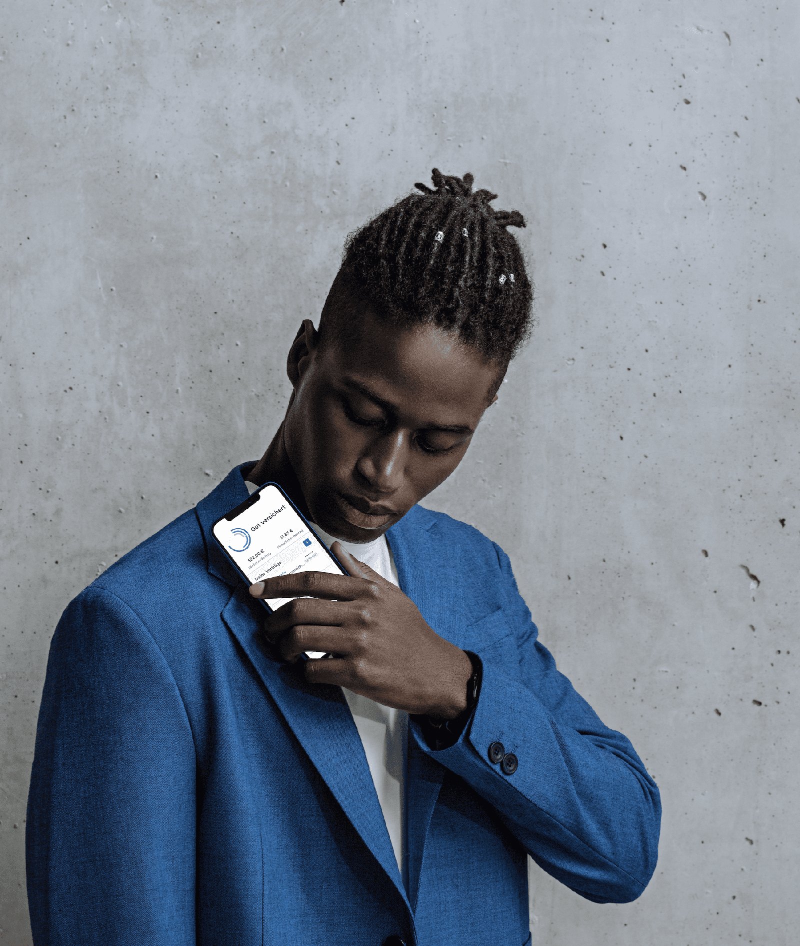 CLARK product photography — a person in a blue suit holding the phone, concrete backdrop